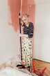 © Melika Tursic/Stocksy - Woman painting wall at home, first move