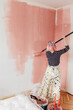 © Melika Tursic/Stocksy - Woman painting wall at home, first move