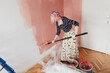 © Melika Tursic/Stocksy - Woman painting wall at home, first move