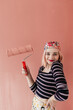 © Melika Tursic/Stocksy - portrait of a happy woman posing with pink brush