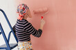 © Melika Tursic/Stocksy - Woman painting wall at home