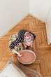 © Melika Tursic/Stocksy - Woman mixing colors for painting wall at home