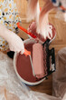 © Melika Tursic/Stocksy - close up of a Woman mixing colors for painting wall at home