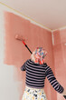 © Melika Tursic/Stocksy - Woman painting wall at home
