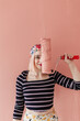 © Melika Tursic/Stocksy - portrait of a woman posing with pink brush
