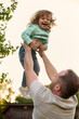 © Iuliia Versta/Stocksy - Dad playing with his little daughter on a backyard