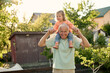 © Iuliia Versta/Stocksy - Grandpa playing with his granddaughter in the backyard
