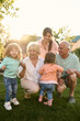 © Iuliia Versta/Stocksy - Portrait of large family playing on a backyard