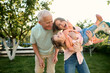 © Iuliia Versta/Stocksy - Young woman with her kid and father playing in the backyard in summer
