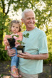 © Iuliia Versta/Stocksy - grandfather with his little granddaughter seeding plants