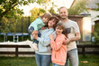 © Iuliia Versta/Stocksy - family portrait on a backyard