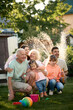 © Iuliia Versta/Stocksy - Family have a fun on a backyard