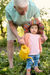 © Iuliia Versta/Stocksy - grandpa with his little granddaughter watered a plants