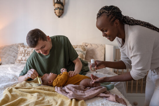 Parents grooming baby