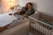 © Milles Studio/Stocksy - Happy couple watching movie while baby sleeping
