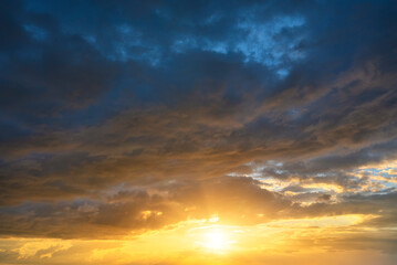 Wall Mural - real sky texture background with bright sun at sunset. dramatic red and orange clouds.