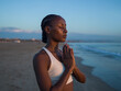© Milles Studio/Stocksy - Woman meditating at beach