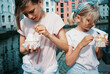 © Tanya Yatsenko/Stocksy - Two girls eating ice cream in the town
