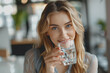 © Chalita - Female entrepreneur enjoys a glass of clean drinking water while working in a modern office.