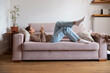 © Danil Nevsky/Stocksy - Young woman relaxing on sofa using mobile phone at home