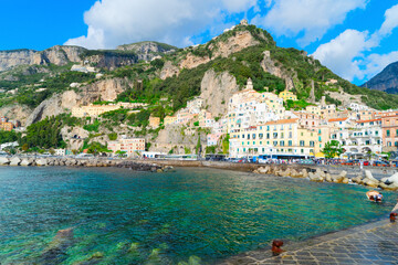 Wall Mural - Amalfi old town and summer beach with umbrellas , Italy