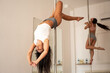 © Aleksandra Jankovic/Stocksy - Women Spinning On The Pole In The Pole Dance Class