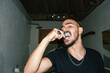 © Laura Herrera/Stocksy - Man brushing his teeth in the bathroom