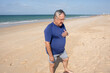 © mahalo studio/Stocksy - Senior man experiencing chest pain on the beach