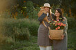 © Iuliia Versta/Stocksy - a portrait of two female florists with a cat and flowers