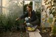 © Iuliia Versta/Stocksy - young female gardener harvests in the greenhouse