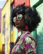 © Espresso - A stylish Black woman with an afro hairstyle, wearing colorful sunglasses and bold earrings in a vibrant urban setting.