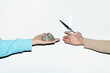 © Colour Laboratory/Stocksy - People playing rock paper scissors game with real objects with flash