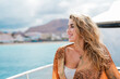 © Daniel - One young blonde and beautiful young woman looking and enjoying summer days in vacation holiday having fun in catamaran boat sailing in the water of sea.
