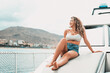 © Daniel - One young attractive girl enjoying summer days relaxed on catamaran in the ocean with turquoise water. Vacation lifestyle concept