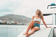 © Daniel - One young attractive girl enjoying summer days relaxed on catamaran in the ocean with turquoise water. Vacation lifestyle concept