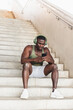 © Diego Martin/Stocksy - Fitness Man Sitting on Outdoor building stairs in Workout Wear