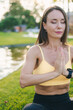 © Strelciuc - A Meditative Woman is Practicing Yoga by the serene Lake in a beautiful natural setting