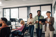 © Zamrznuti tonovi - Diverse business team collaborating on digital tablet in modern office