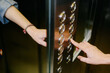 © Artem Zhushman/Stocksy - Unrecognisable Person Pressing the Elevator Button