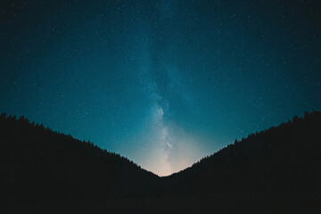 Wall Mural - A dark sky with a few stars and a bright moon