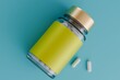 © Sky-Blue Creative/Stocksy - Supplement Bottle with Yellow Label and Gold Cap on Blue Background