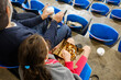 © Jimena Roquero/Stocksy - Unrecognizable audience in arena eating on grandstand