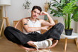 © mahalo studio/Stocksy - tattooed man relaxing in a modern apartment