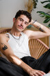 © mahalo studio/Stocksy - man with tattoos is relaxing at home