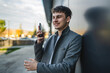 © Miljan Živković - young handsome man talk on mobile phone on the black wall background