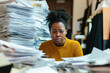© smth.design - Overwhelmed African American woman at desk with stacks of paperwork