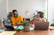 © Hernandez & Sorokina/Stocksy - Cheerful People Working At The Desk Indoors