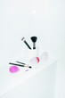 © Colour Laboratory/Stocksy - Make-up essentials: sponges, brushes, liners on toilet with flashlight