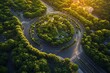 © Abdul - Aerial view of a circular road surrounded by lush greenery at sunset.