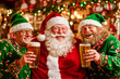 © Sunshower Shots - Santa Claus and two elves drinking beer in a pub, Christmas holiday cheer